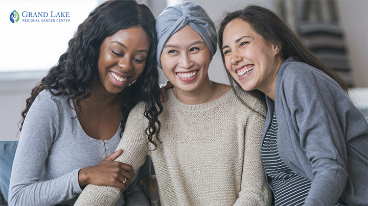Three female friends smiling